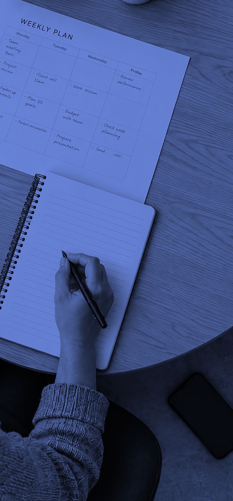 Planning a work week with a notebook and calendar